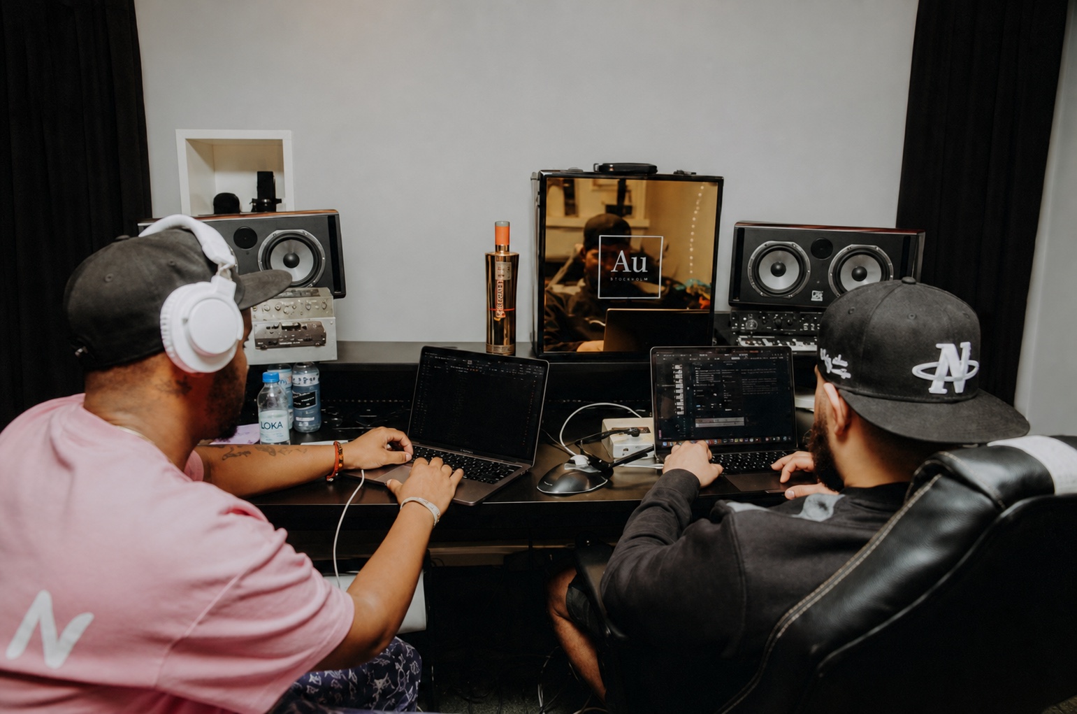 Two producers making music at the EuroSync Stockholm camp with AU Vodka in the studio